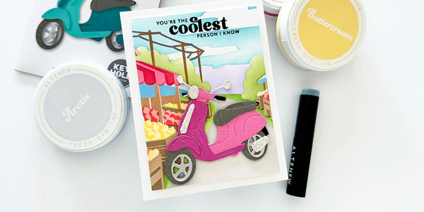 Colorful handmade scene card created with Altenew Rural Farmland Layering Stencil, ink blending, and Let's Scoot die cuts.