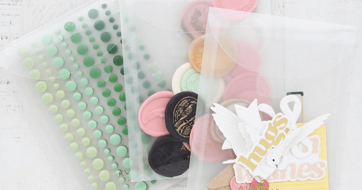 3 clear storage pouches from Altenew filled with enamel dots, ready to use wax seals, and ready to use die-cuts