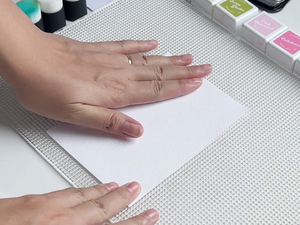 Position your cardstock or stencil on the mat