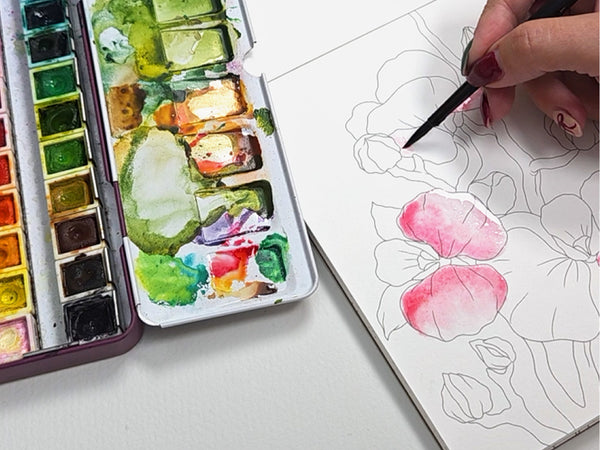 Use your brush to apply paint to your coloring book, canvas, or watercolor paper