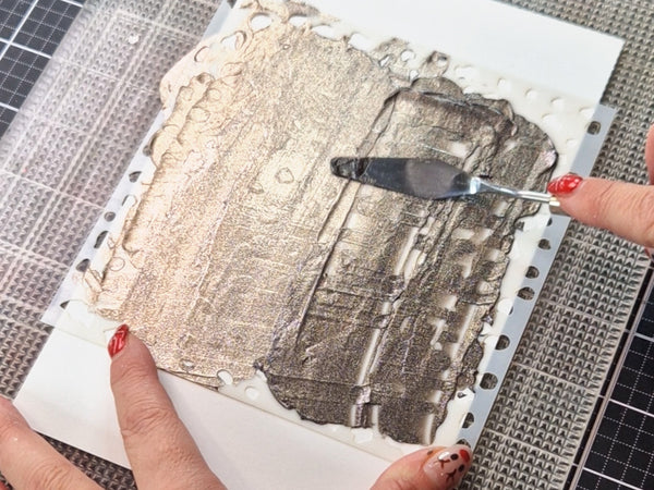Spread a thin, even layer of paste over the design using a palette knife.