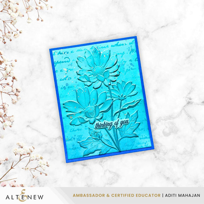 Altenew Paper Echoes stencil featuring a detailed oxeye daisy design on silver pigment ink paper.