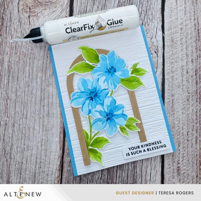 Altenew ClearFix Glue adhesive bottle with deep blue seas and woodland design on the label, ideal for craft and paper projects.