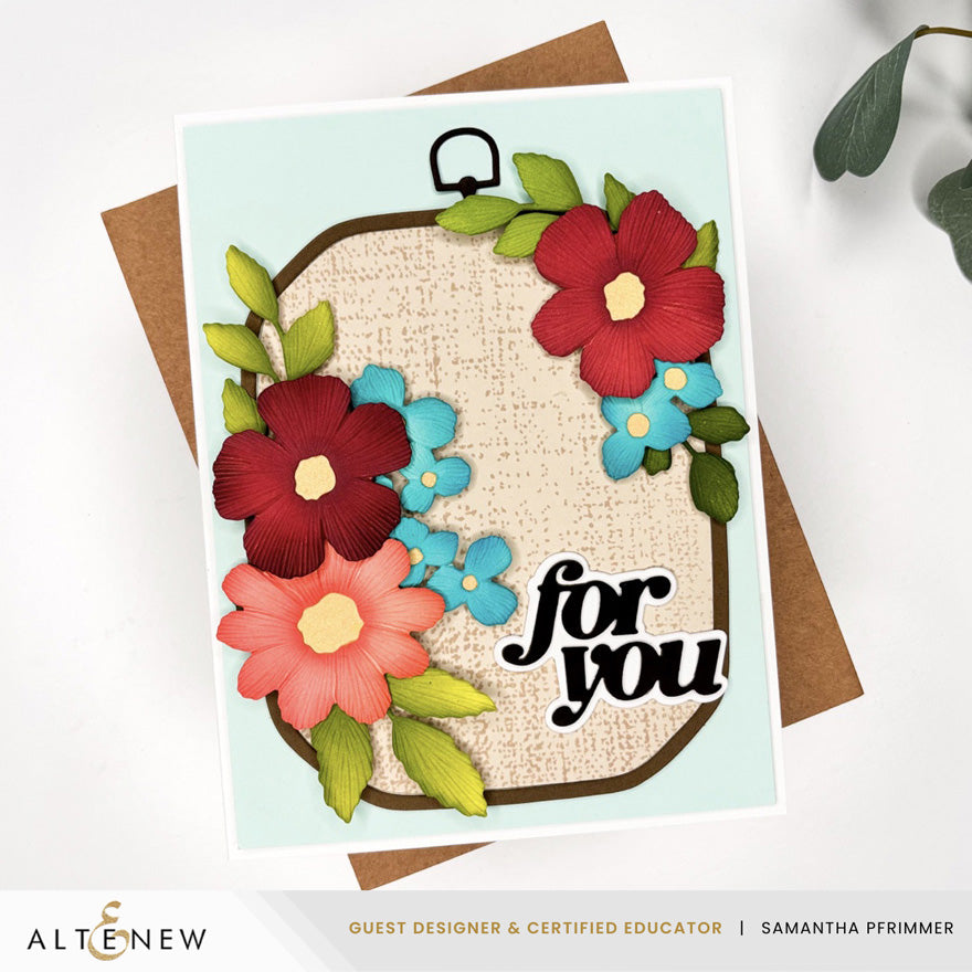 Altenew Zero-Waste Embroidered Florals die set on rustic linen background, showcasing intricate floral die cuts for crafting projects.