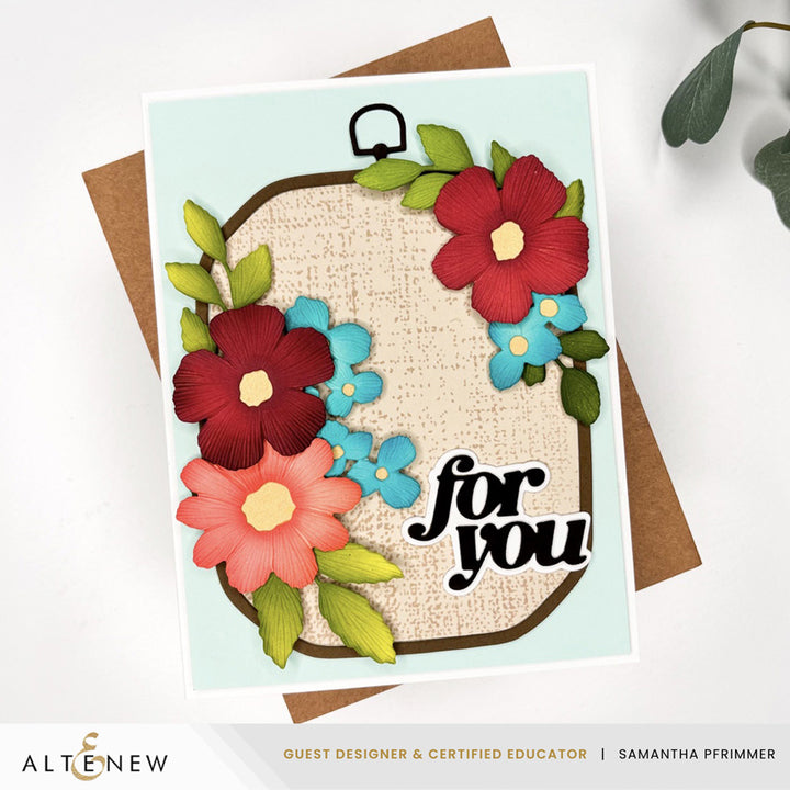 Altenew Zero-Waste Embroidered Florals die set on rustic linen background, showcasing intricate floral die cuts for crafting projects.