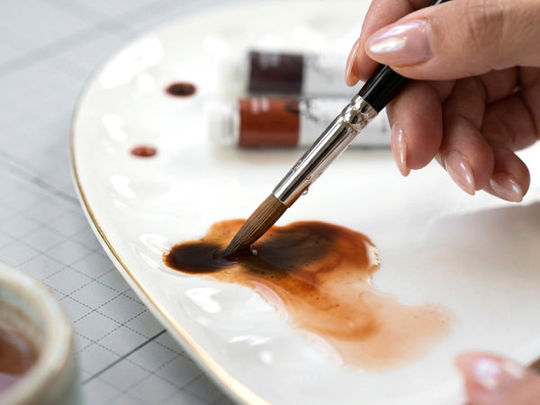 Wet your brush with water and mix the paint.