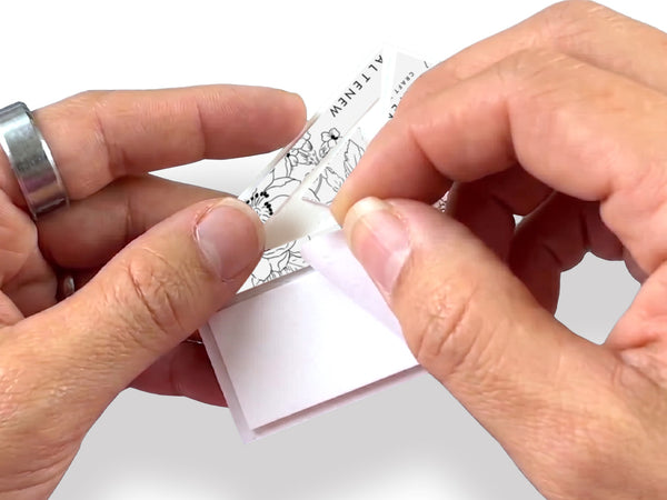 Press the tape firmly onto the back of your project, then remove the easy-peel liner.