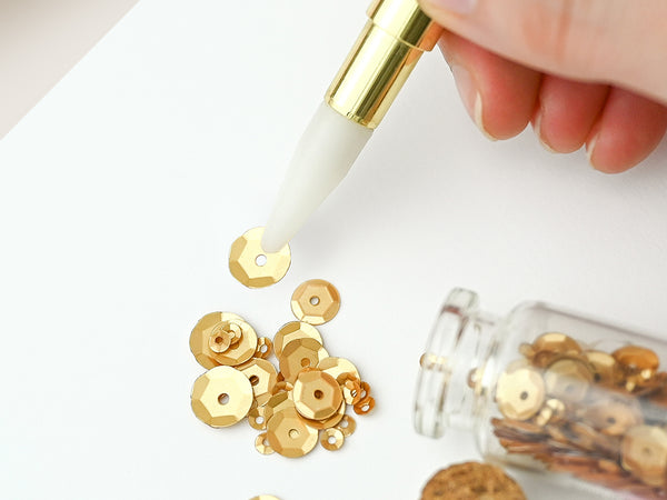 Pick up tiny pieces using the wax tip.