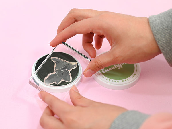 Tap ink onto the stamp and press it on your paper.
