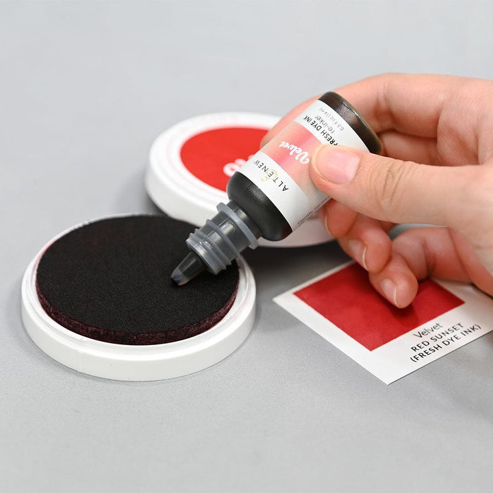 Altenew Red Sunset Fresh Dye Ink Reinker bottle with red, blush, crimson, and velvet ink colors for crafting and stamping projects.
