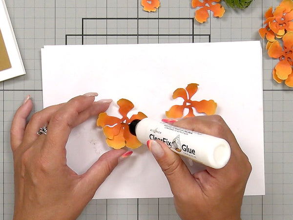 Apply a small amount of glue onto your die-cut or embellishment.