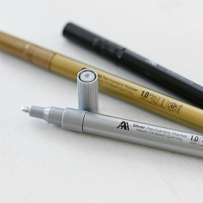 Set of Altenew Essential Permanent Markers showing colorful ink tips and labels, ideal for stationery and gift projects.