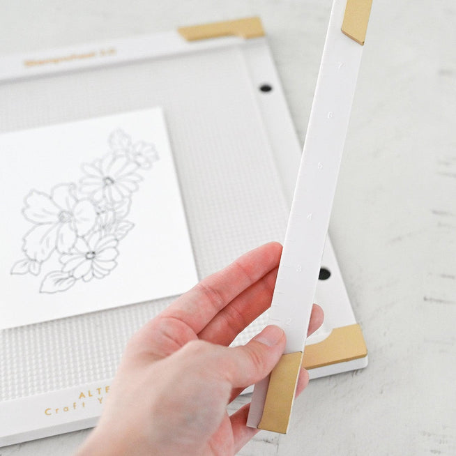 Altenew Stampwheel 2.0 tools for stamping and crafting, featuring a circular stamping guide and precision hardware.