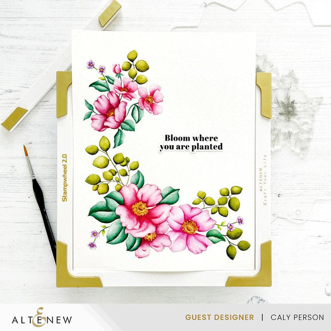 Altenew Stampwheel 2.0 tool for stamping and crafting, featuring a circular design with adjustable sections for precise stamping.