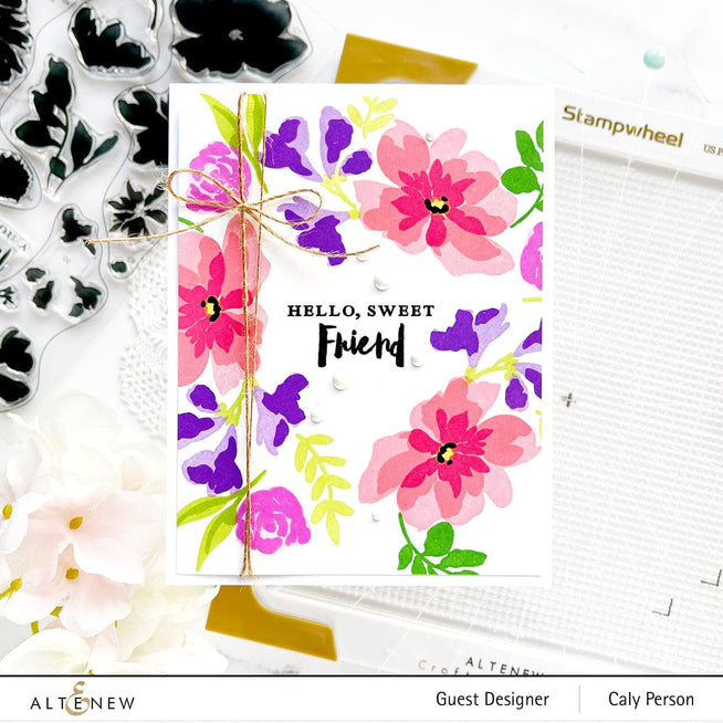 Altenew Stampwheel 1.0 Meta tool with colorful stamps and ink pads for crafting and stamping projects.