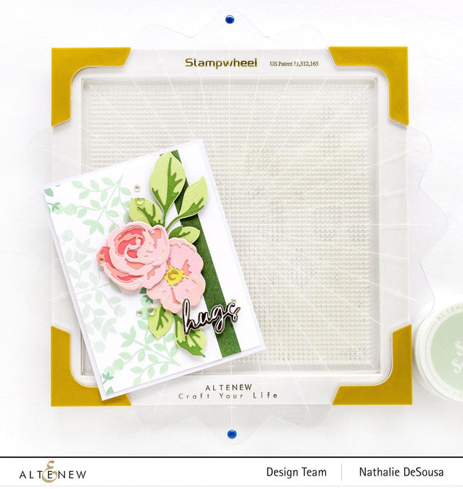 Altenew Stampwheel 1.0 Meta tool with colorful stamps and wheels for creative crafting and stamping projects.