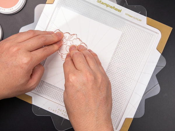 Position your stamp on the cardstock & pick it up using the flip plate